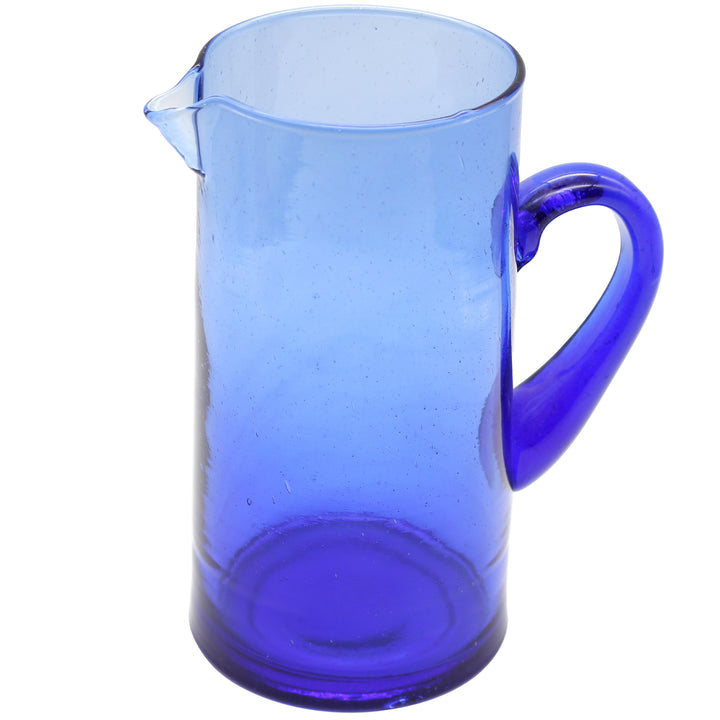 Blue carafe made of mouth-blown glass with curved handle
